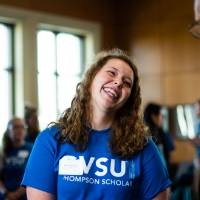 A Thompson Scholar is laughing with Robert and Ellen Thompson.